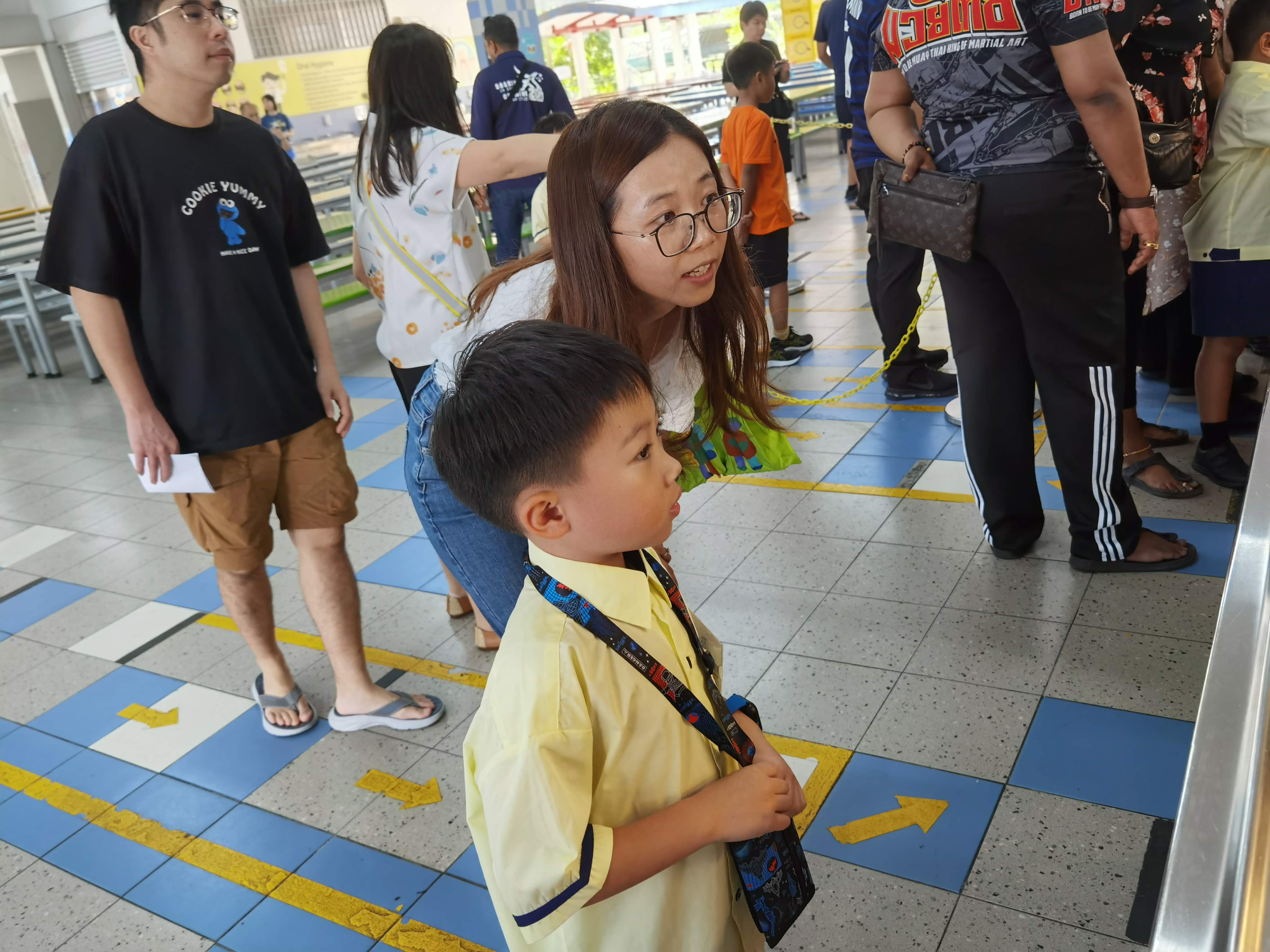 A new primary 1 student learning how to order at the canteen for the first time